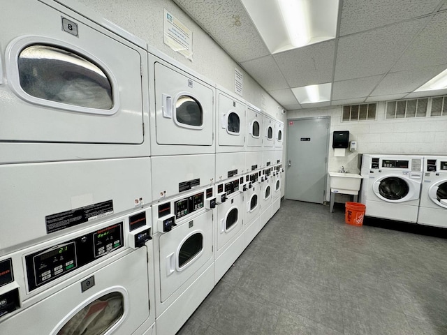 1850 N Clark St Unit 2406, Chicago, IL 60614 - community laundry featuring stacked washing machine and dryer, washing machine and dryer, and tile patterned floors
