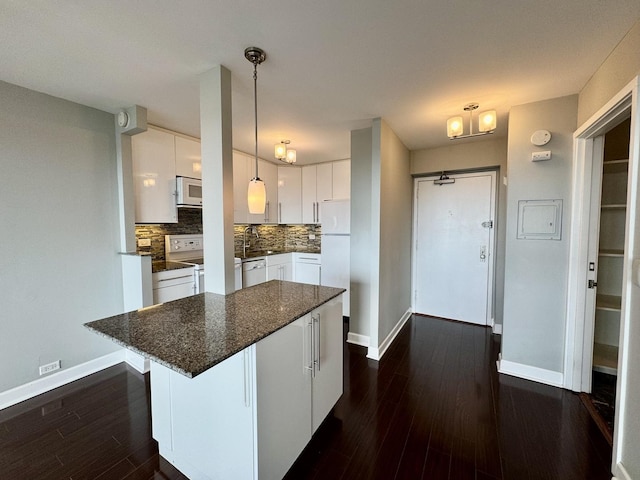 1850 N Clark St Unit 2406, Chicago, IL 60614 - kitchen featuring white appliances, decorative backsplash, white cabinetry, dark wood-style floors, and a kitchen island