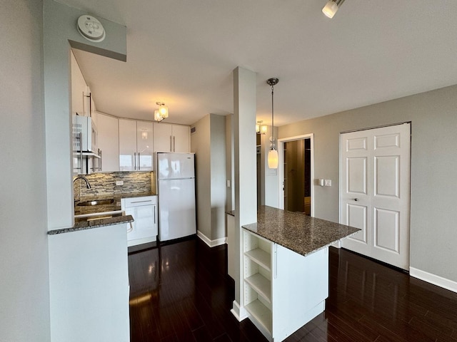 1850 N Clark St Unit 2406, Chicago, IL 60614 - kitchen with freestanding refrigerator, open shelves, white cabinetry, tasteful backsplash, and dark wood finished floors