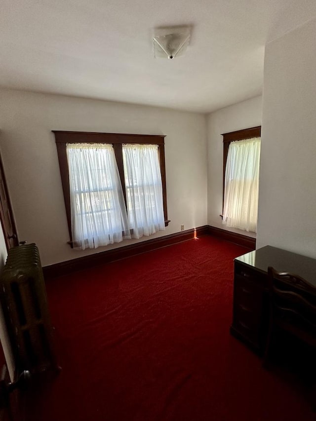 605 Washington St, Prophetstown, IL 61277 - empty room with radiator heating unit and carpet