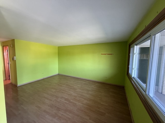 5925 W Montrose Ave Unit 3C, Chicago, IL 60634 - spare room with wood finished floors and baseboards