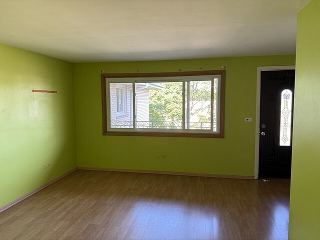 5925 W Montrose Ave Unit 3C, Chicago, IL 60634 - unfurnished room featuring wood finished floors and healthy amount of natural light