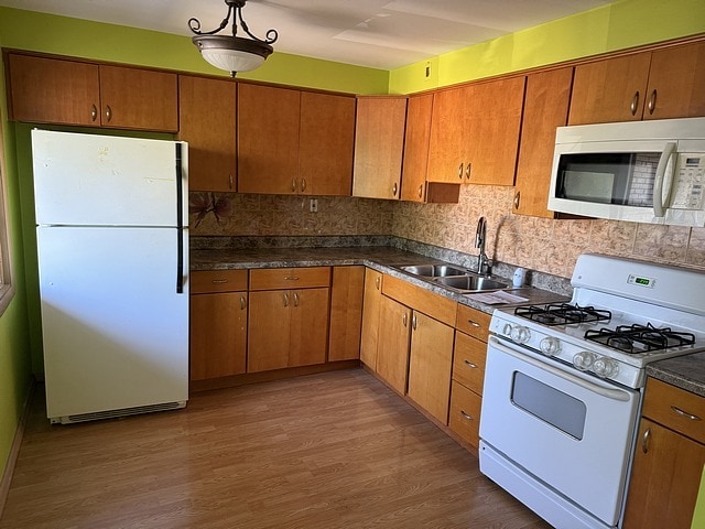 5925 W Montrose Ave Unit 3C, Chicago, IL 60634 - kitchen featuring white appliances, wood finished floors, and brown cabinets
