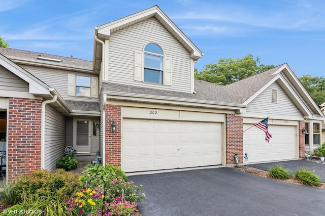 202 Woodboro Dr, West Chicago, IL 60185 - traditional home featuring asphalt driveway, brick siding, and roof with shingles