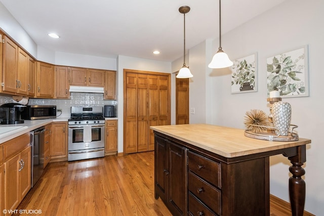 202 Woodboro Dr, West Chicago, IL 60185 - kitchen with stainless steel appliances, under cabinet range hood, wooden counters, light wood finished floors, and tasteful backsplash