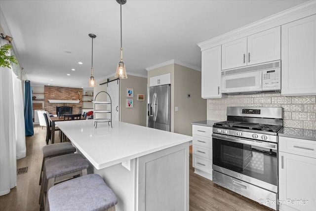 218 Foxmoor Rd, Fox River Grove, IL 60021 - kitchen featuring stainless steel appliances, wood finished floors, open floor plan, white cabinetry, and recessed lighting