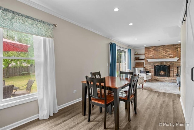218 Foxmoor Rd, Fox River Grove, IL 60021 - dining room featuring wood finished floors, ornamental molding, a brick fireplace, and recessed lighting