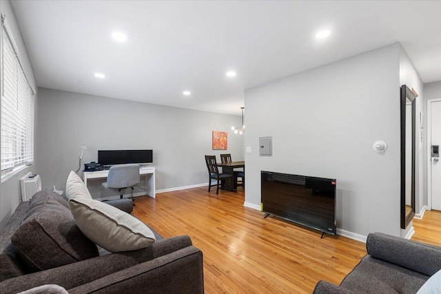 1415 W Lunt Ave Unit 402, Chicago, IL 60626 - living room featuring light wood-type flooring, a chandelier, and recessed lighting