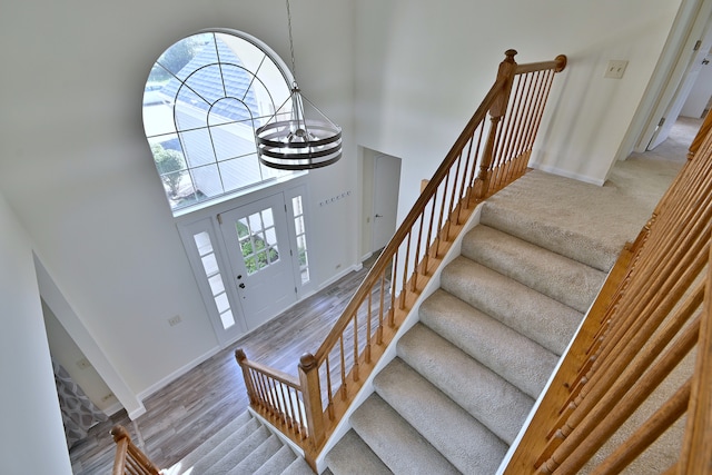 2020 Medinah Cir, Elgin, IL 60123 - foyer entrance with a high ceiling, a chandelier, stairs, and wood finished floors