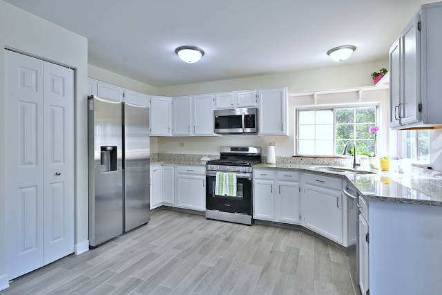 2020 Medinah Cir, Elgin, IL 60123 - kitchen with stainless steel appliances, light stone countertops, light wood-style flooring, and white cabinetry