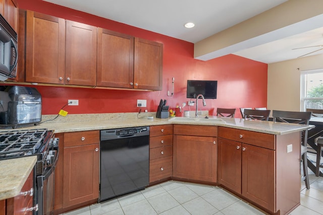 1929 Diamond Head Trl, Pingree Grove, IL 60140 - kitchen featuring black appliances, a peninsula, light tile patterned floors, brown cabinetry, and a kitchen breakfast bar