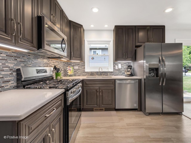 3916 N Adams St, Westmont, IL 60559 - kitchen with appliances with stainless steel finishes, dark brown cabinetry, tasteful backsplash, light countertops, and recessed lighting