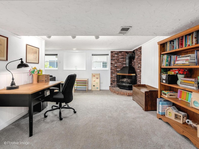 3916 N Adams St, Westmont, IL 60559 - carpeted office featuring a wood stove and a textured ceiling