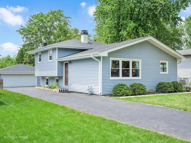 3916 N Adams St, Westmont, IL 60559 - split level home featuring a chimney, a front yard, roof with shingles, a garage, and an outbuilding
