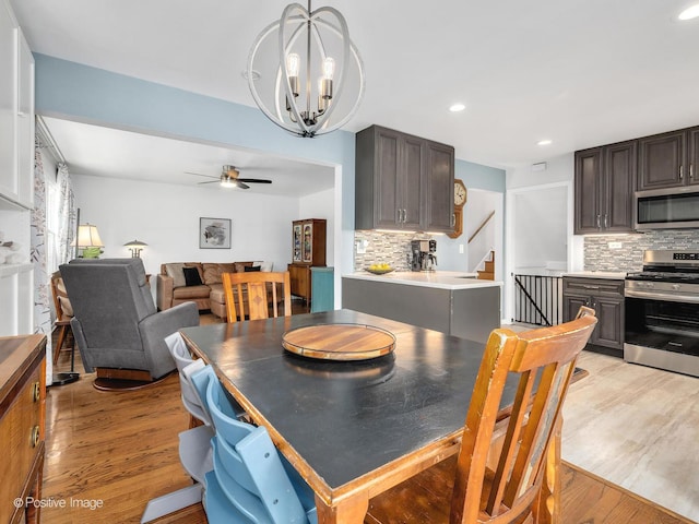3916 N Adams St, Westmont, IL 60559 - dining room with light wood-style floors, a ceiling fan, stairs, recessed lighting, and a chandelier