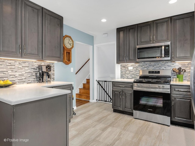 3916 N Adams St, Westmont, IL 60559 - kitchen with appliances with stainless steel finishes, light countertops, decorative backsplash, light wood-type flooring, and recessed lighting