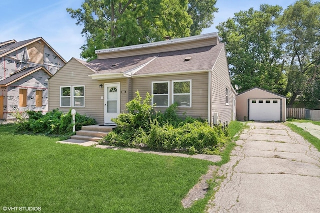 14449 Kenton Ave, Midlothian, IL 60445 - view of front of home featuring asphalt driveway, an outdoor structure, a garage, and a shingled roof