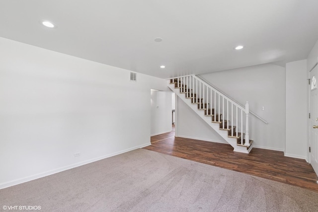 14449 Kenton Ave, Midlothian, IL 60445 - unfurnished living room with carpet floors, stairs, recessed lighting, and wood finished floors