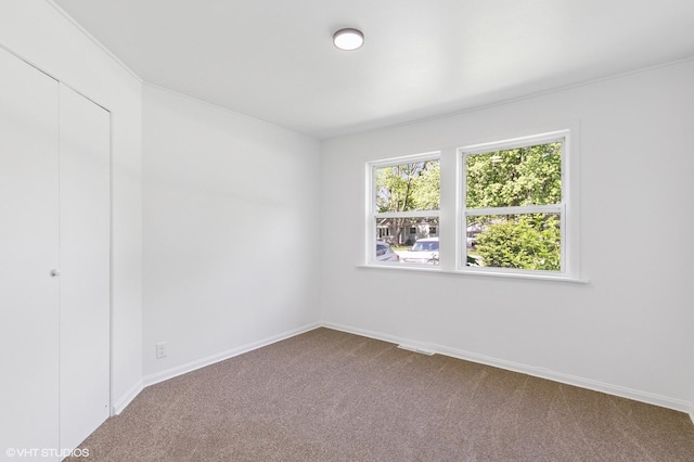 14449 Kenton Ave, Midlothian, IL 60445 - unfurnished bedroom with dark carpet and a closet