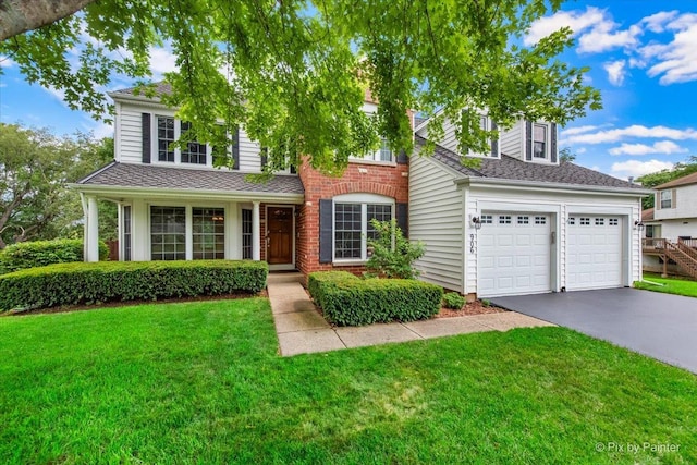 906 Ridgewood Dr, Cary, IL 60013 - traditional-style home with driveway, a garage, a front yard, and roof with shingles