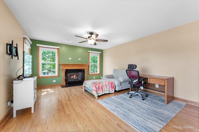 906 Ridgewood Dr, Cary, IL 60013 - bedroom featuring wood finished floors, a fireplace with flush hearth, and ceiling fan