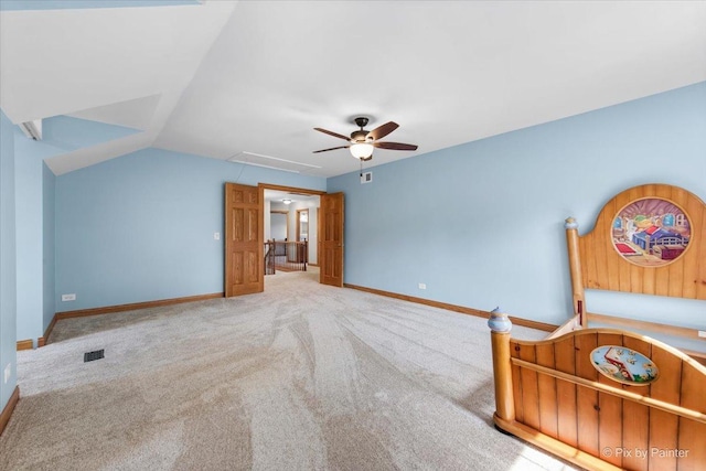 906 Ridgewood Dr, Cary, IL 60013 - unfurnished bedroom with attic access, carpet, vaulted ceiling, and a ceiling fan