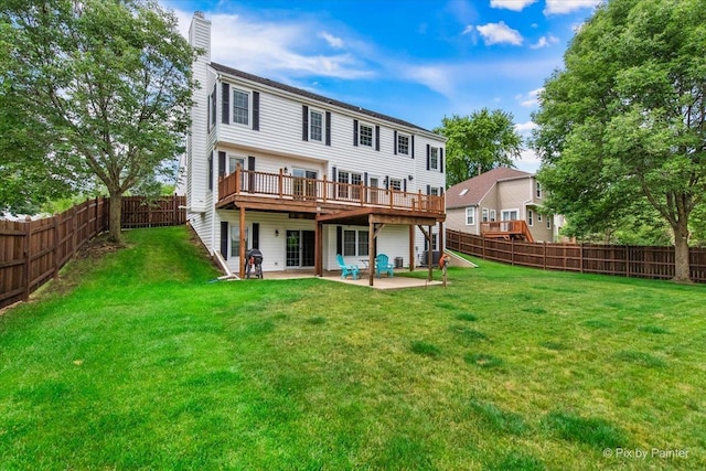 906 Ridgewood Dr, Cary, IL 60013 - back of property featuring a chimney, a patio, a wooden deck, and a fenced backyard