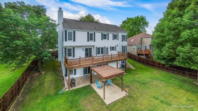 906 Ridgewood Dr, Cary, IL 60013 - rear view of property featuring a patio, a chimney, a fenced backyard, a wooden deck, and a shingled roof