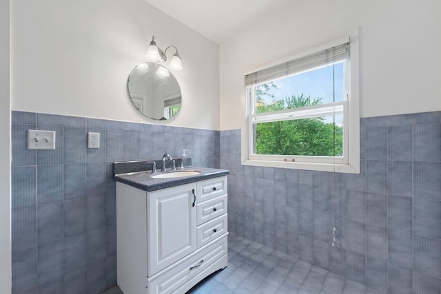 2326 Hancock St, Rockford, IL 61103 - bathroom featuring tile walls, vanity, a wainscoted wall, and tile patterned floors