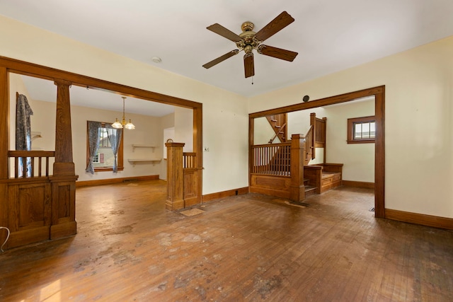 2326 Hancock St, Rockford, IL 61103 - unfurnished room featuring hardwood / wood-style floors, a chandelier, ceiling fan, stairs, and cooling unit