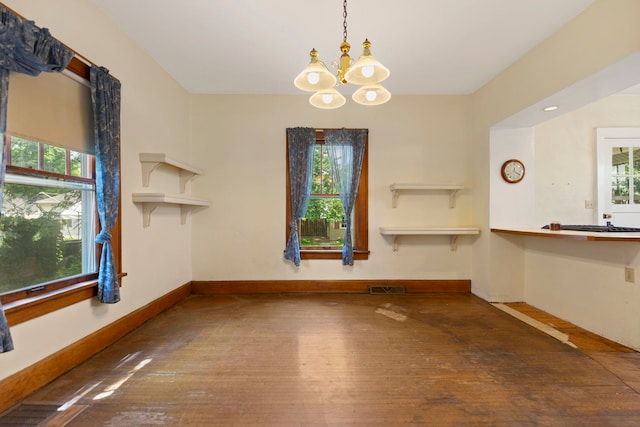 2326 Hancock St, Rockford, IL 61103 - unfurnished dining area featuring a chandelier and wood-type flooring