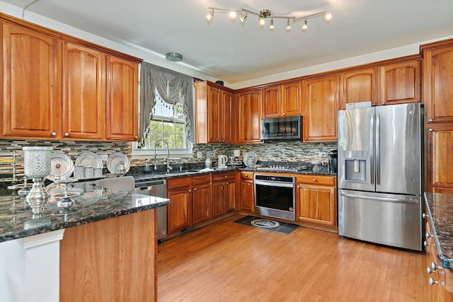 1285 Mallard Ln, Hoffman Estates, IL 60192 - kitchen featuring appliances with stainless steel finishes, light wood finished floors, brown cabinets, and dark stone counters
