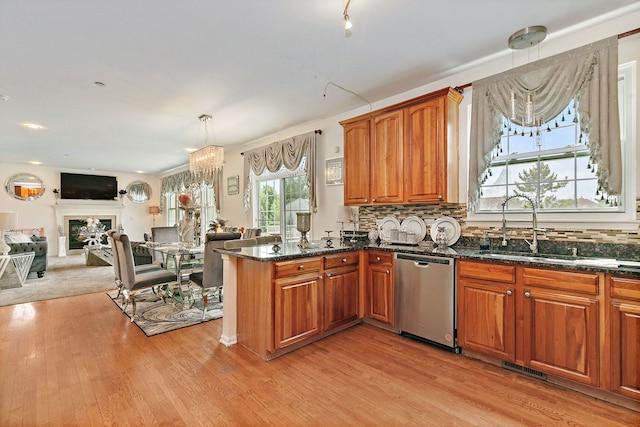 1285 Mallard Ln, Hoffman Estates, IL 60192 - kitchen featuring dishwasher, light wood-type flooring, brown cabinets, a peninsula, and dark stone countertops