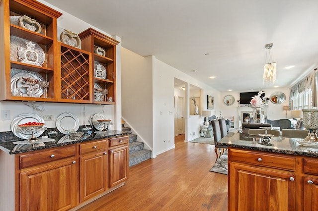 1285 Mallard Ln, Hoffman Estates, IL 60192 - kitchen featuring open shelves, light wood-style flooring, open floor plan, and dark stone countertops