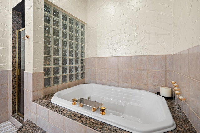 925 E 49th St, Chicago, IL 60615 - bathroom with a tub with jets, tile walls, and a stall shower