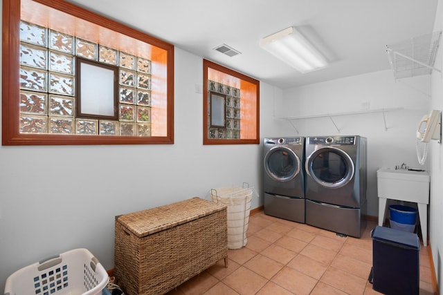 925 E 49th St, Chicago, IL 60615 - laundry room with washer and dryer and light tile patterned flooring
