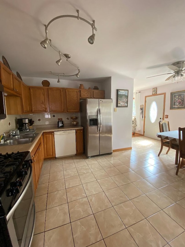 1601 Cherokee Dr, Round Lake Beach, IL 60073 - kitchen featuring stainless steel appliances, light tile patterned flooring, light countertops, brown cabinets, and ceiling fan