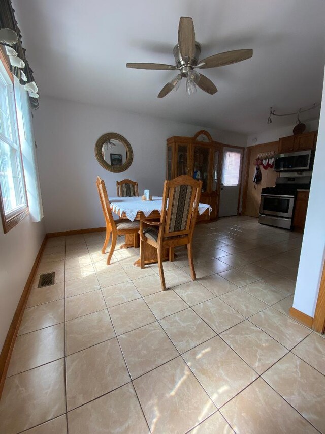 1601 Cherokee Dr, Round Lake Beach, IL 60073 - dining space with light tile patterned floors and ceiling fan