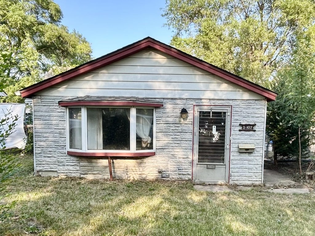 2407 Horeb Ave, Zion, IL 60099 - rear view of house with stone siding and a lawn