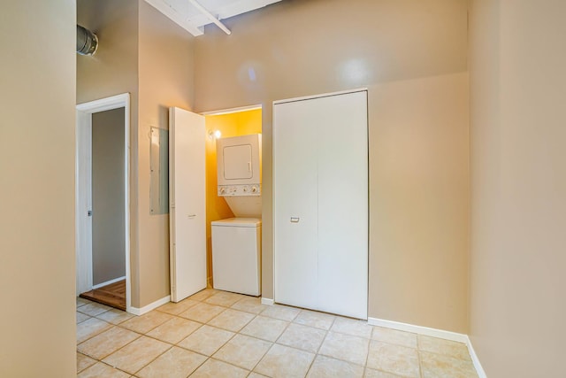 5200 S Ellis Ave Unit 318, Chicago, IL 60615 - unfurnished bedroom featuring stacked washing machine and dryer, light tile patterned floors, a closet, and a high ceiling