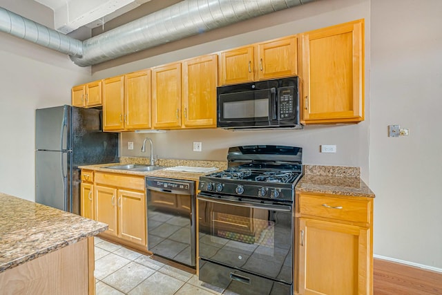 5200 S Ellis Ave Unit 318, Chicago, IL 60615 - kitchen featuring black appliances, light brown cabinetry, and light tile patterned floors