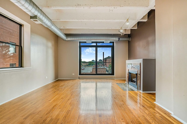 5200 S Ellis Ave Unit 318, Chicago, IL 60615 - unfurnished living room featuring wood finished floors, beamed ceiling, and a tile fireplace