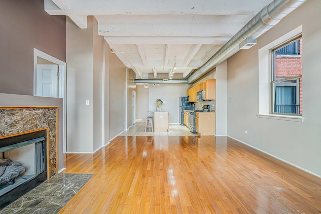 5200 S Ellis Ave Unit 318, Chicago, IL 60615 - unfurnished living room with light wood finished floors and a tiled fireplace