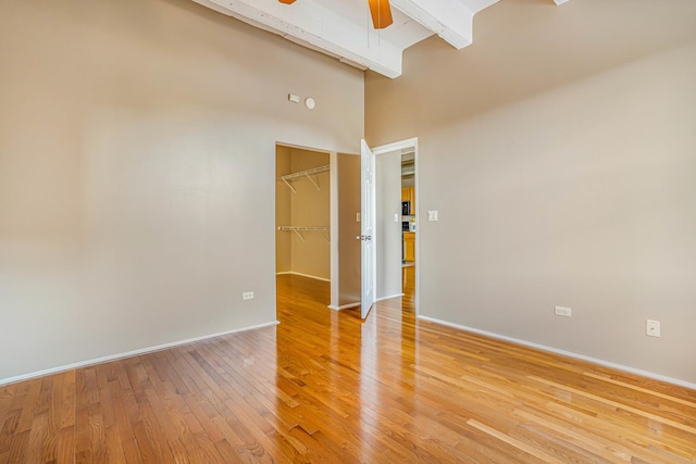 5200 S Ellis Ave Unit 318, Chicago, IL 60615 - spare room featuring light wood finished floors, a ceiling fan, a high ceiling, and beam ceiling