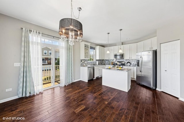 10589 153rd Pl, Orland Park, IL 60462 - kitchen with appliances with stainless steel finishes, a chandelier, light countertops, white cabinets, and tasteful backsplash