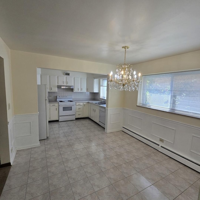 1041 N NW Hwy Unit A4, Park Ridge, IL 60068 - kitchen with white appliances, baseboard heating, a chandelier, a decorative wall, and white cabinets