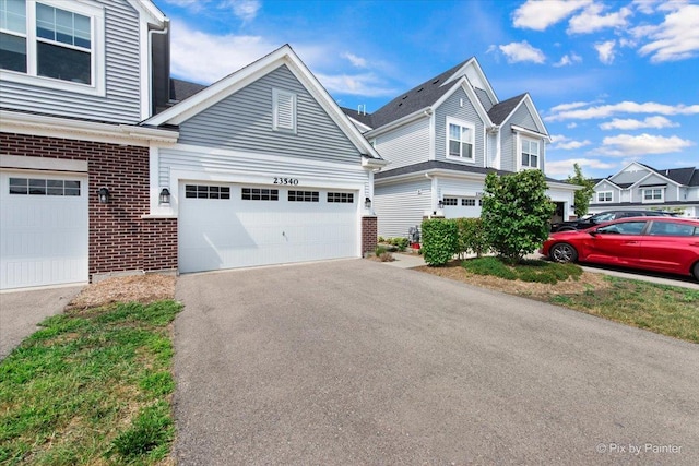23540 W Bancroft Dr Unit 0, Plainfield, IL 60585 - traditional-style home with brick siding, a garage, and asphalt driveway