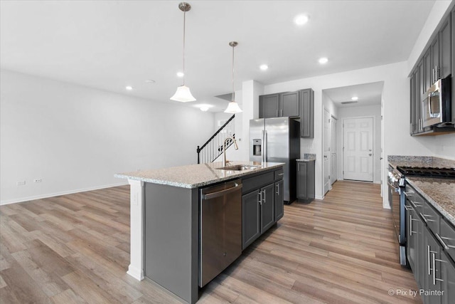 23540 W Bancroft Dr Unit 0, Plainfield, IL 60585 - kitchen with stainless steel appliances, light wood-style floors, recessed lighting, light stone countertops, and a kitchen island with sink
