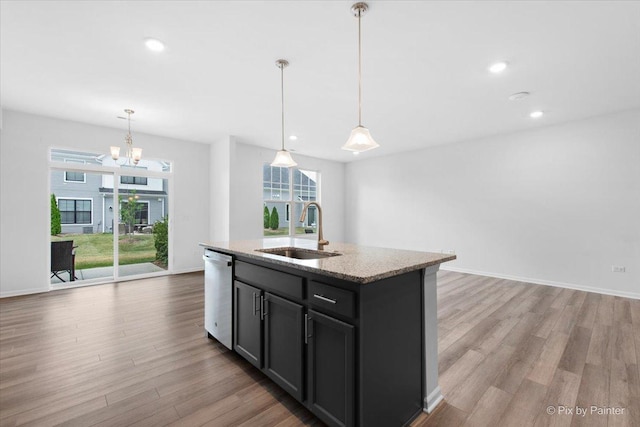 23540 W Bancroft Dr Unit 0, Plainfield, IL 60585 - kitchen featuring dishwasher, light wood-type flooring, light stone counters, a kitchen island with sink, and hanging light fixtures