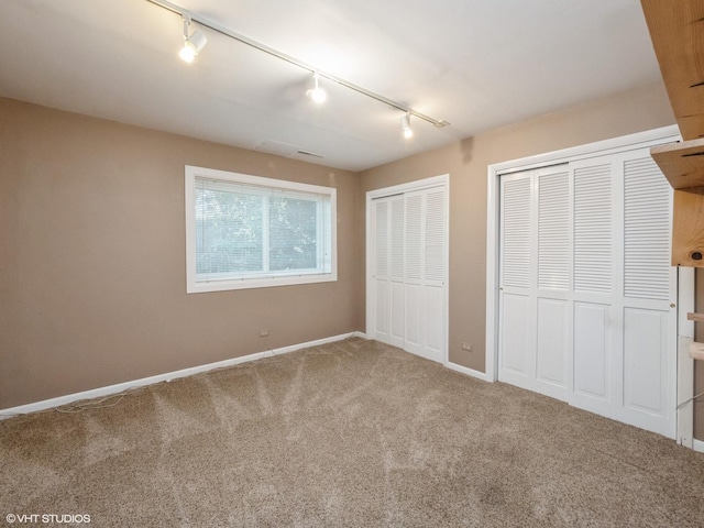 235 S Cedar St, Palatine, IL 60067 - unfurnished bedroom featuring track lighting, multiple closets, and carpet floors